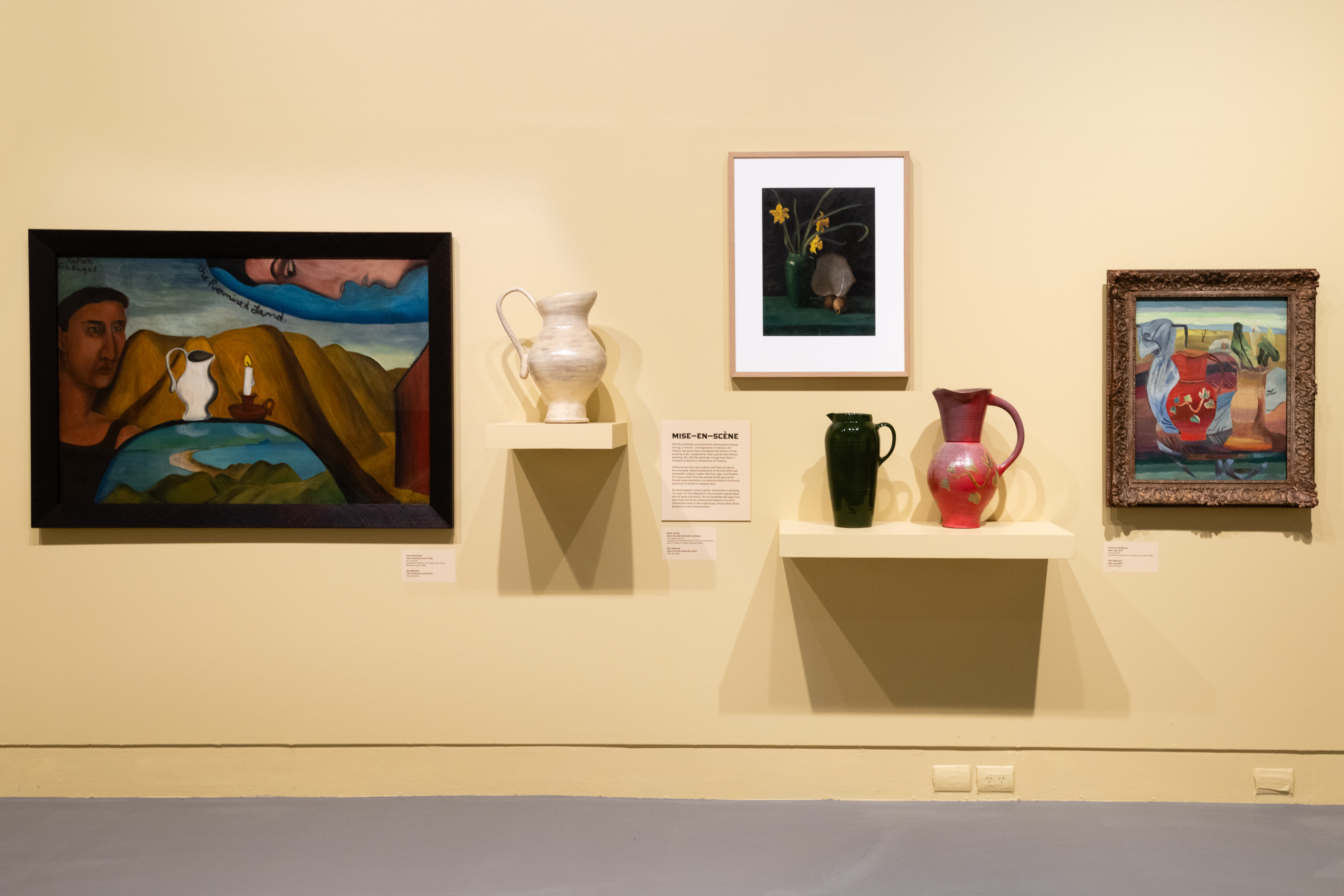 An installation shot of Paul Maseyk's jugs with the paintings they are responding to. This image features the work of Colin McCahon, Edith Collier and Frances Hodgkins.