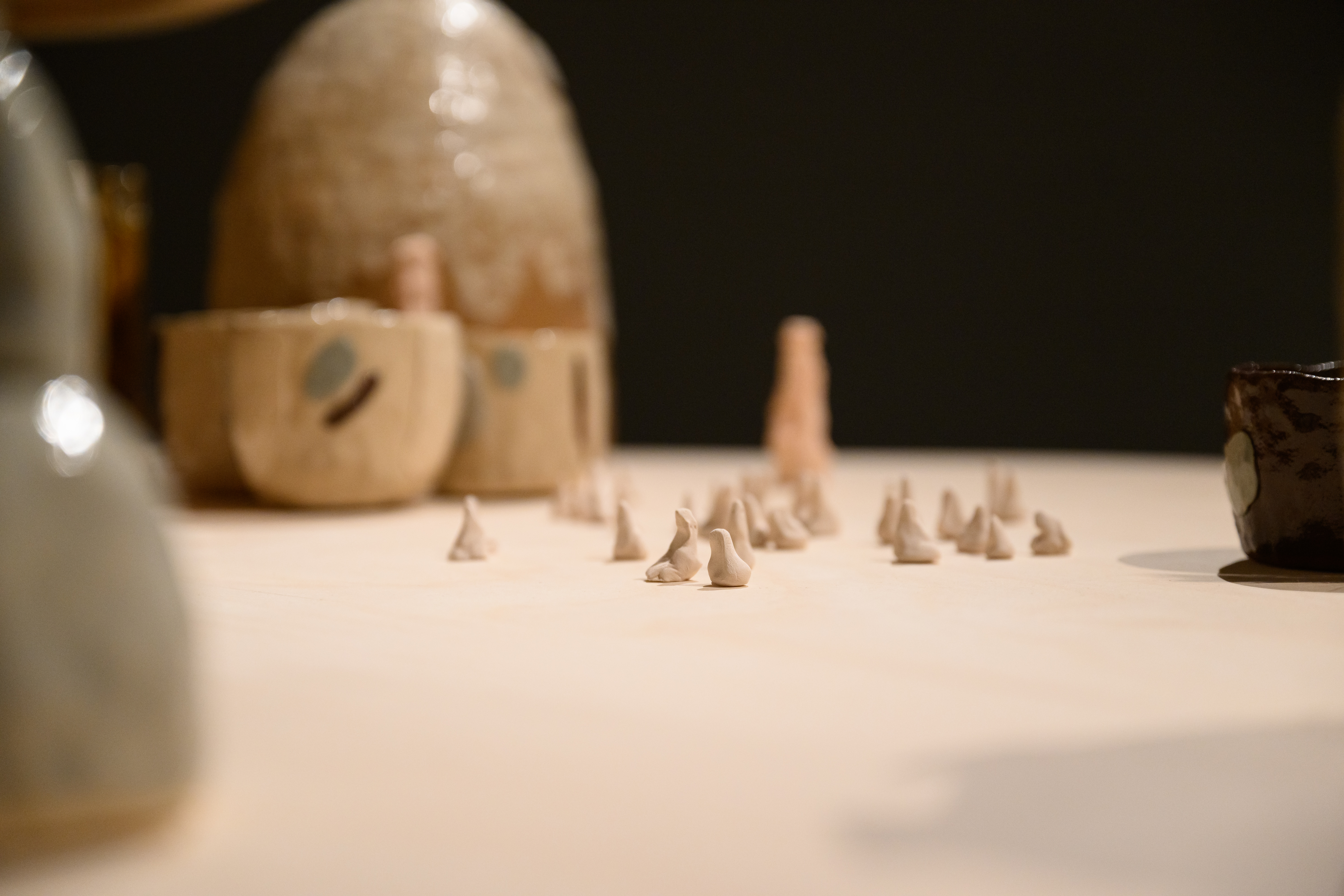 Close up of table surface, with little ceramic critters grouped together